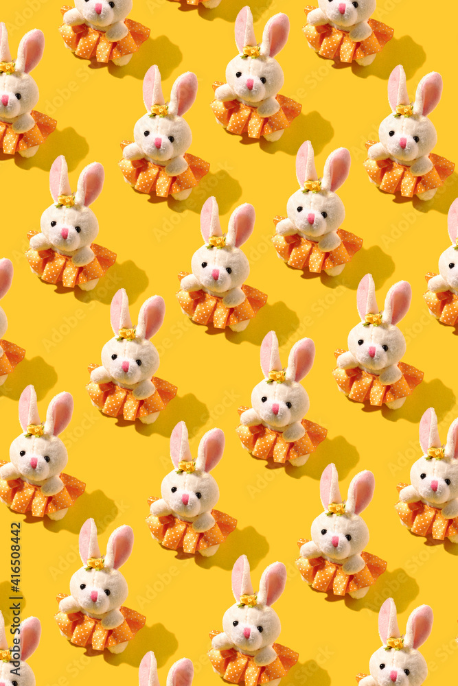 Pattern with rabbit toy. Creative background for celebration of Easter.