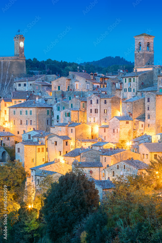 View of old town in the evening night with old tradition buildings and illumination. Sorano, Tuscany, Italy