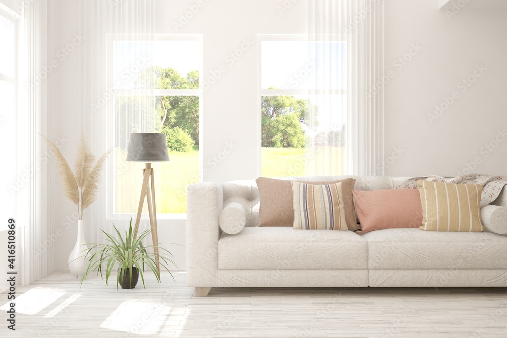 Fototapeta premium White living room with sofa and summer landscape in window. Scandinavian interior design. 3D illustration