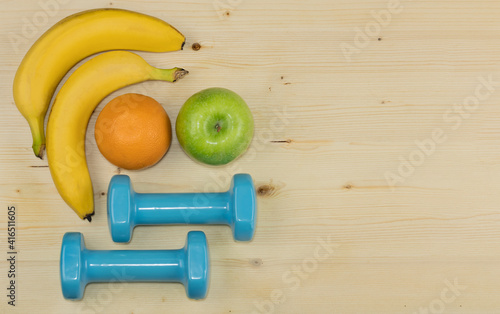Healthy food and fitness, fresh friut, bananas, green apple, orange, wood background