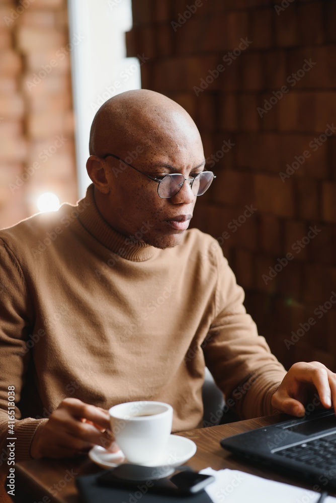 African american business man with laptop in a cafe African american business man with laptop in a cafe