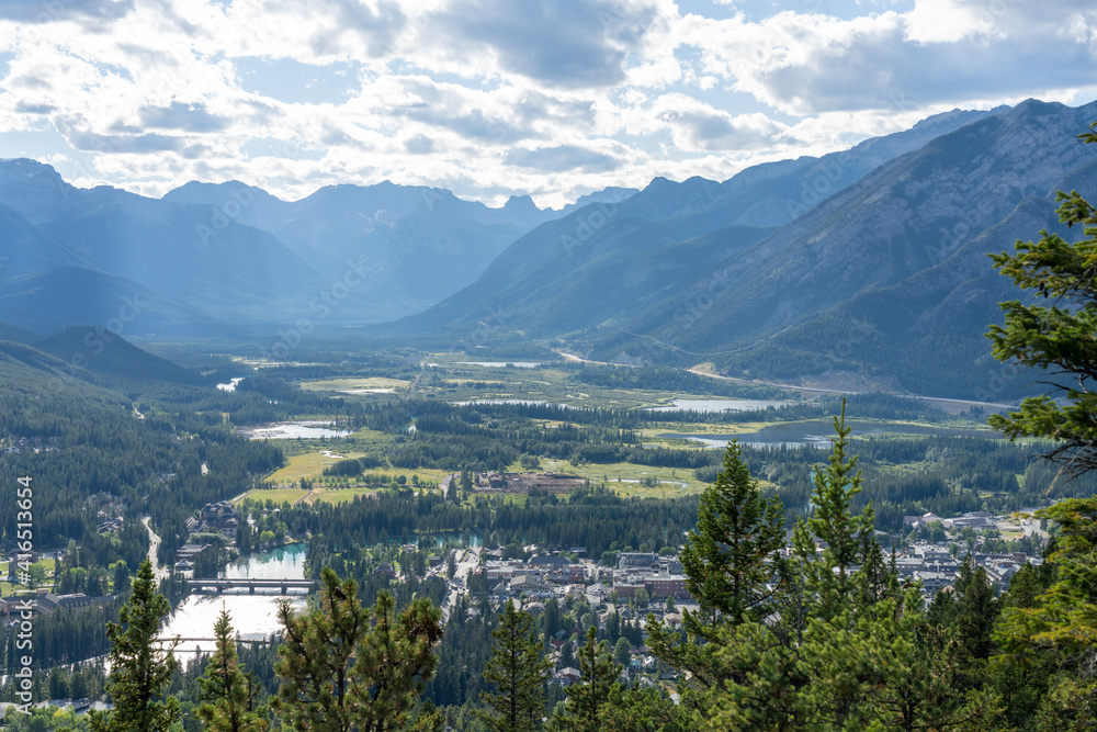 Overlooking the Town of Banff from Tunnel Mountain Trail summit in summer sunny day. Banff National Park, Canadian Rockies, Alberta, Canada.