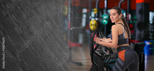 Woman using modern elliptical machine in gym, space for text. Banner design