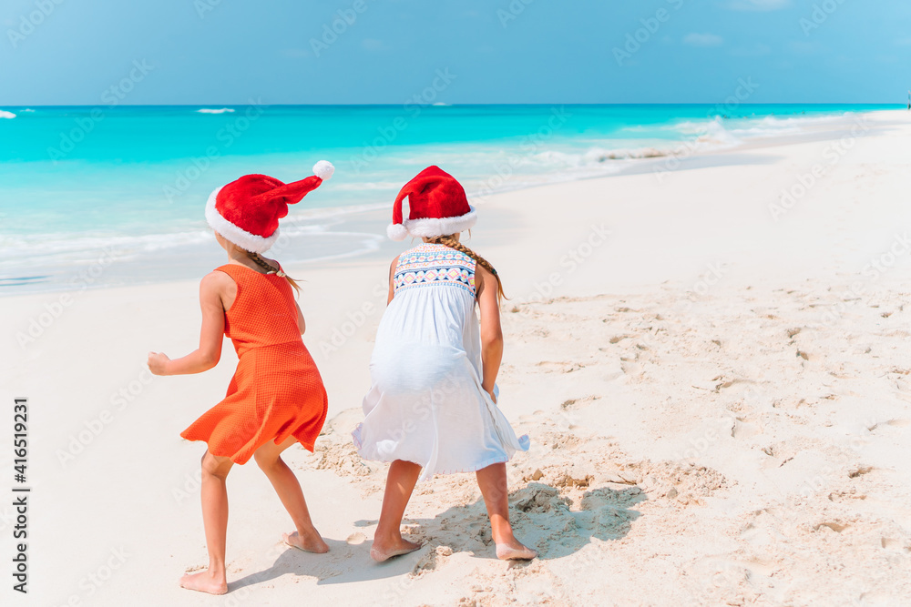 Adorable little girls with starfish on white empty beach Adorable little girls with starfish on white empty beach