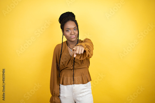 African american woman wearing casual clothes ointing with finger to the camera and to you, confident gesture looking serious photo