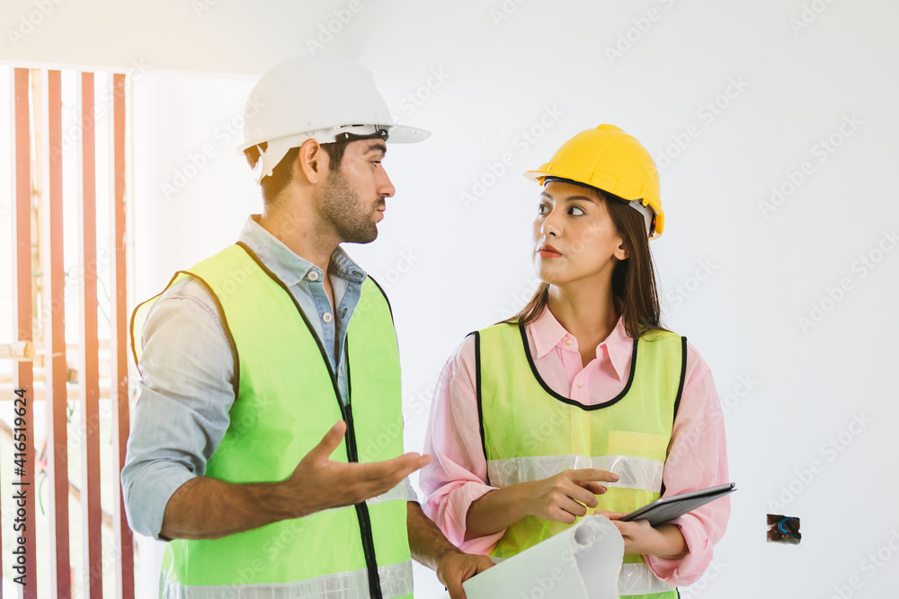 Team of young caucasian, asian man and woman contractor, partner explain and inspecting the reconstructed construction and renovated to check defect of apartment, home,house at job site, workplace. Team of young caucasian, asian man and woman contractor, partner explain and inspecting the reconstructed construction and renovated to check defect of apartment, home,house at job site, workplace.