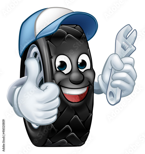 A tyre cartoon car mechanic service mascot holding a spanner and giving a thumbs up
