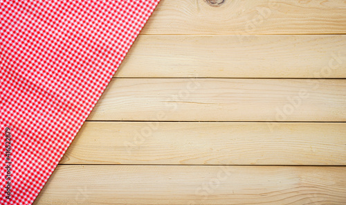 Wood table with classic pink plaid fabric or tablecloth in the corner