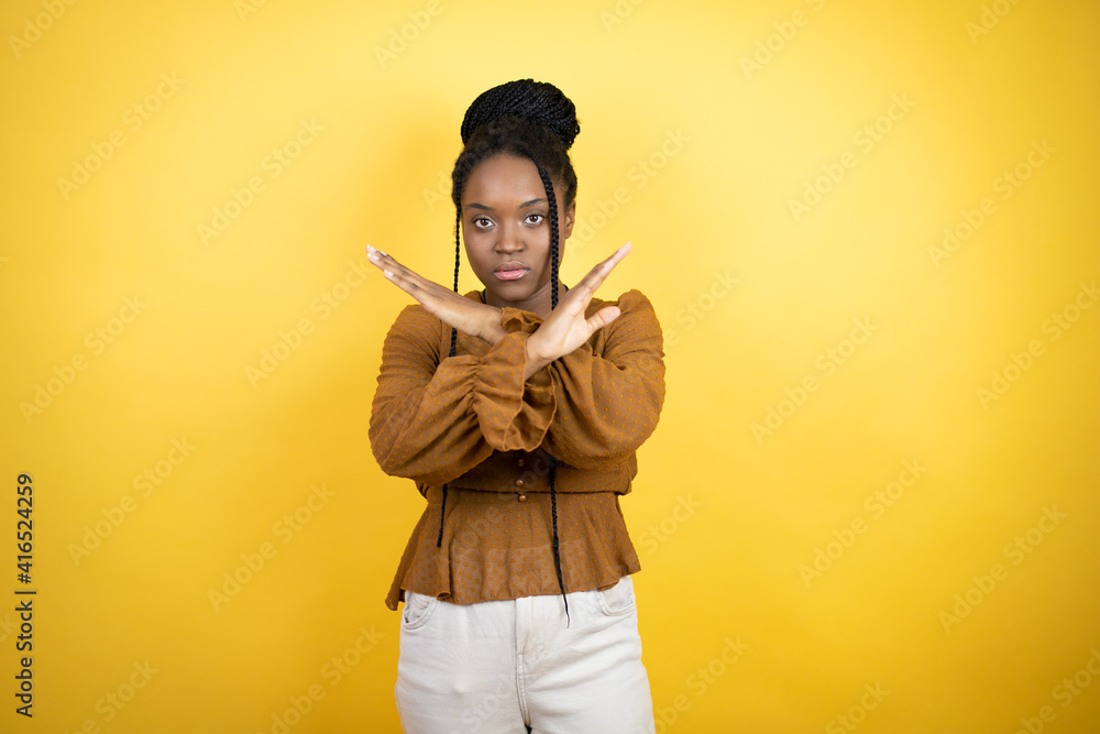African american woman wearing casual clothes Rejection expression crossing arms doing negative sign, angry face African american woman wearing casual clothes Rejection expression crossing arms doing negative sign, angry face