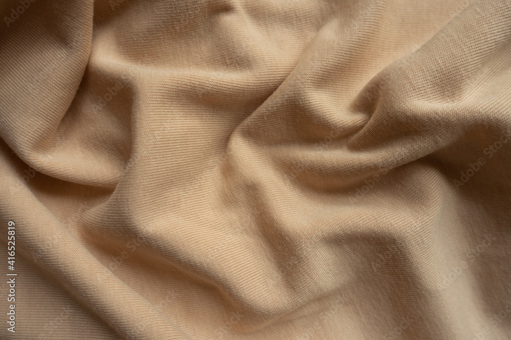 Rippled simple beige cotton jersey fabric from above