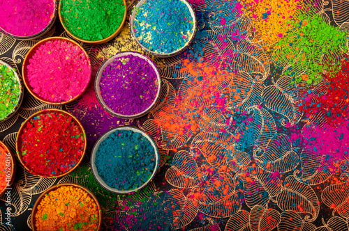 Fototapet Happy Holi top view of colorful holi colors in bowls with Splash, Concept Indian color festival