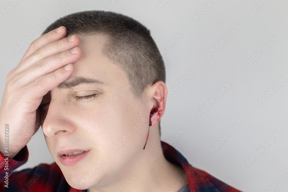 A man whose ear is bleeding. Vascular rupture, damage to the tympanic membrane, ear diseases, oncology, otitis media, myringitis A man whose ear is bleeding. Vascular rupture, damage to the tympanic membrane, ear diseases, oncology, otitis media, myringitis