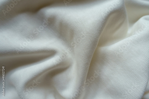 Crumpled simple white cotton jersey fabric from above