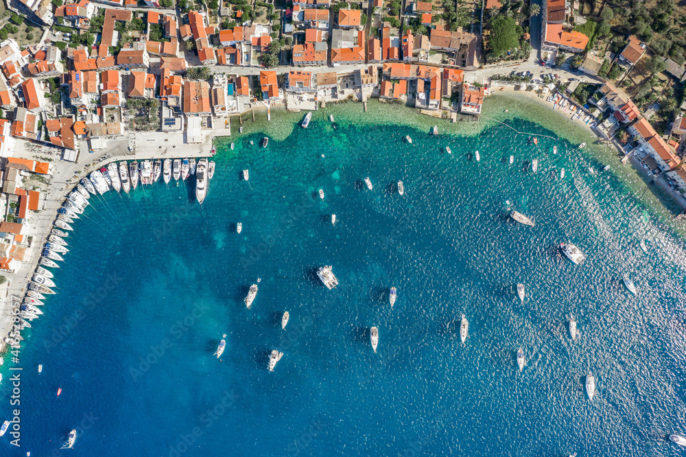 Aerial overhead drone shot of yachts on Adriatic sea near Vis Island in Croatia summer