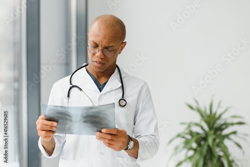 African doctor looking at a radiography