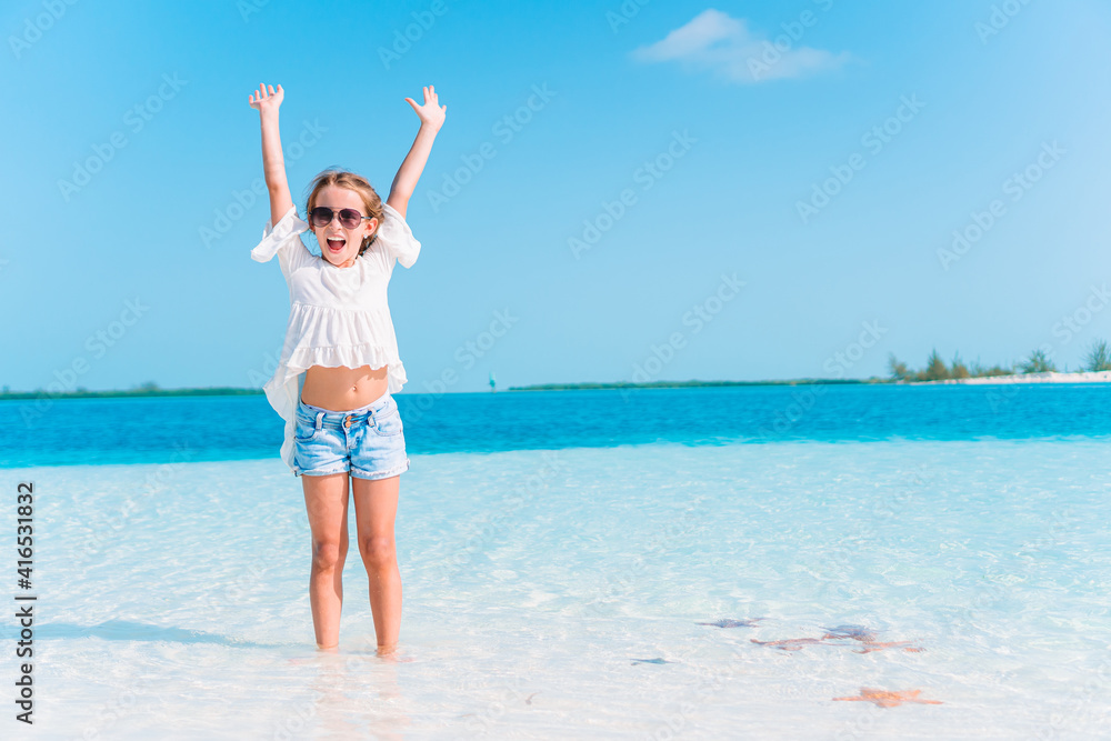 Adorable little girl have fun at tropical beach during vacation Adorable little girl have fun at tropical beach during vacation