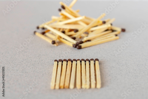 Lots of matches on a light background. The concept of chaos and order. Selective focus.