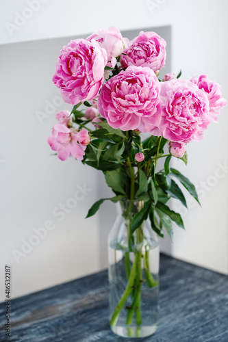 Flower bouquet of pink natural peonies flowers in a vase