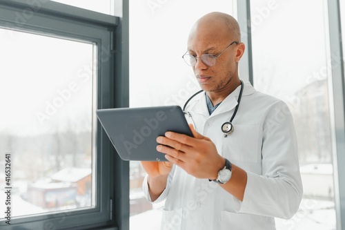 African doctor looking at a radiography
