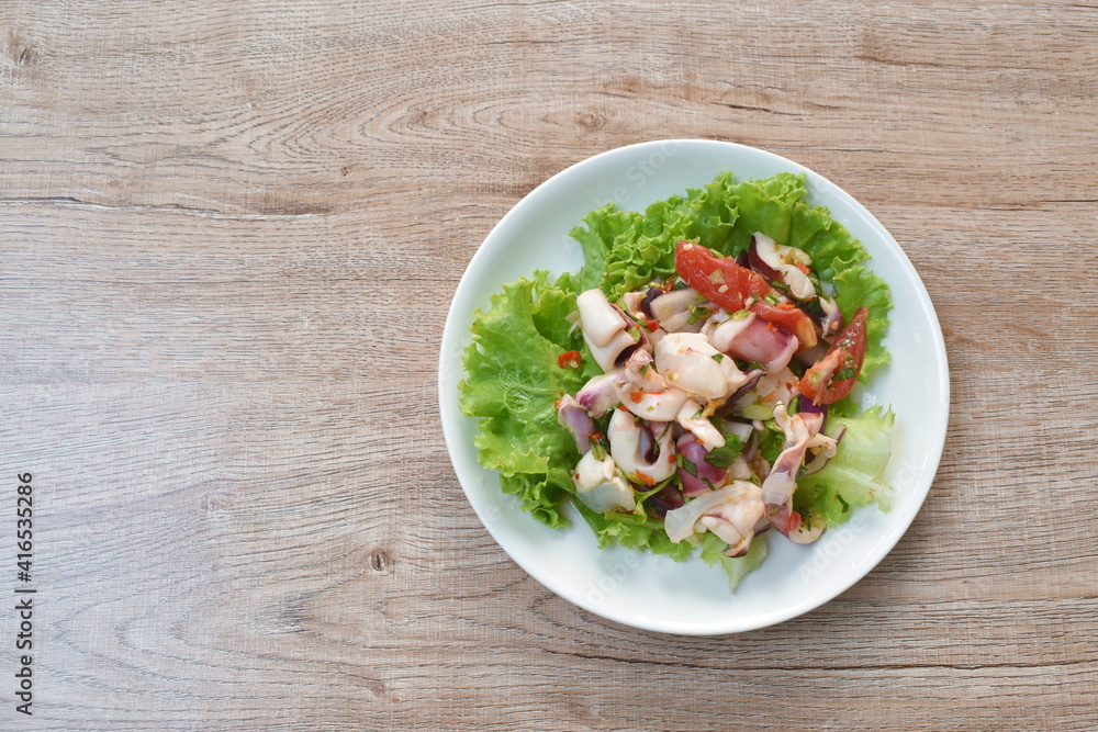 Thai spicy squid salad and fresh vegetable on plate Thai spicy squid salad and fresh vegetable on plate
