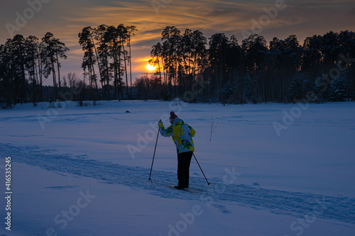 An elderly man on skis.. Sunset sun. Active senior experienced mature old person in ski