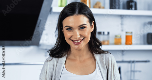 Free Download Brunette woman smiling at camera in kitchen - GFXLoad
