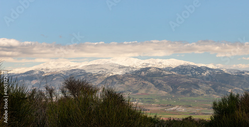 View of the snow-capped peak of Mount Hermon and the valley under the mountain from the observation point of Mitzpe Benay in northern Israel