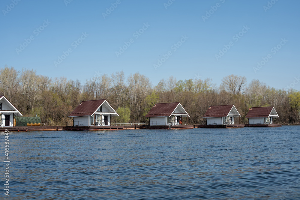 wooden houseboats on the river in the spring wooden houseboats on the river in the spring