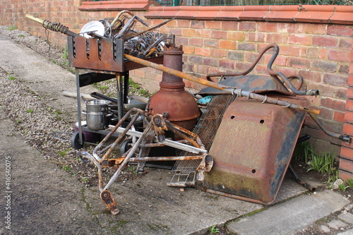 Domestic rusty scrap metal pile at the edge of a homes drive awaiting collection