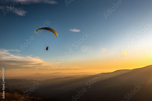 paraglider flies over the mountains