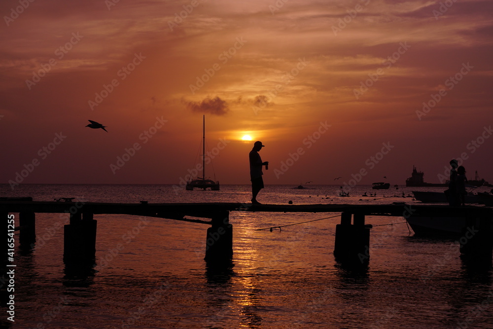 Fototapeta premium silhouette of a person on a pier