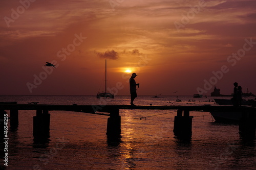 silhouette of a person on a pier