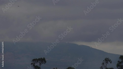 Timelapes for mountain and the cloud are flying over it very fast photo