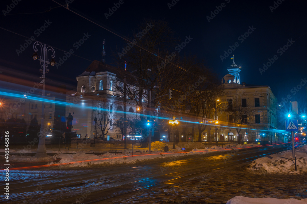 Night Lviv old city architecture in the winter season. Buildings highlighted by the illumination