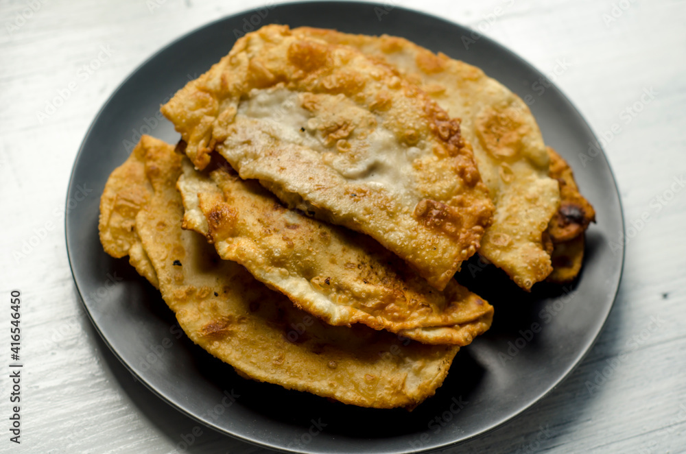 Fried flatbread with meat filling. Known in Asia as chebureks. Fried flatbread with meat filling. Known in Asia as chebureks.