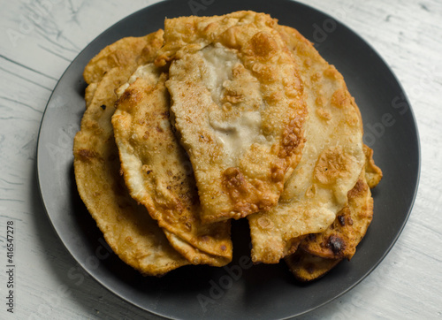 Fried flatbread with meat filling. Known in Asia as chebureks.