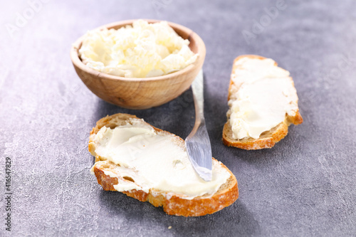 cottage cheese- bowl of cheese and slice of bread