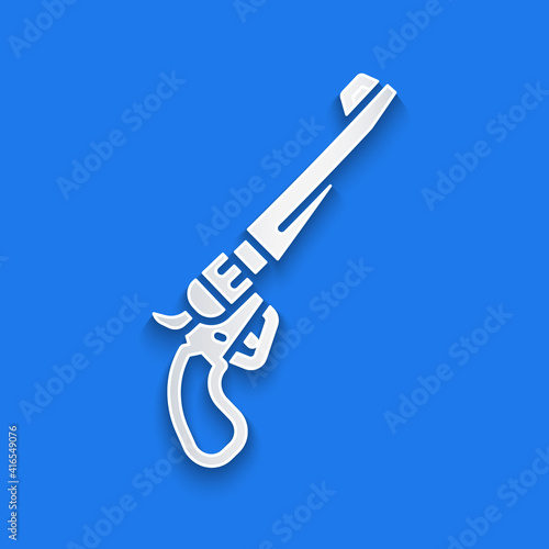Paper cut Revolver gun icon isolated on blue background. Paper art style. Vector.
