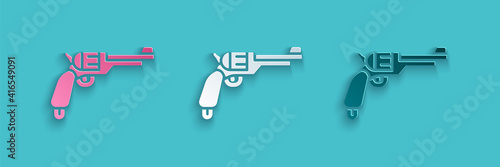 Paper cut Revolver gun icon isolated on blue background. Paper art style. Vector.