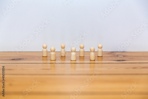 Wooden people figures on a wooden floor 