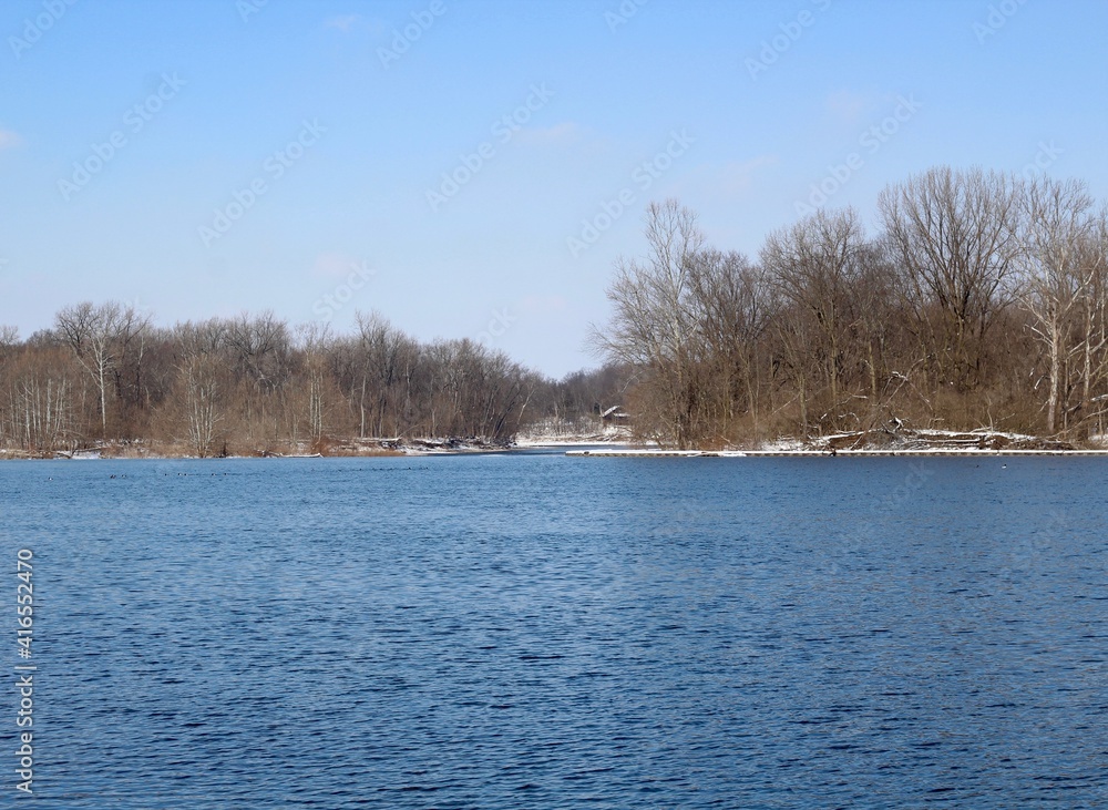 The flowing river on a cold sunny winter day. The flowing river on a cold sunny winter day.