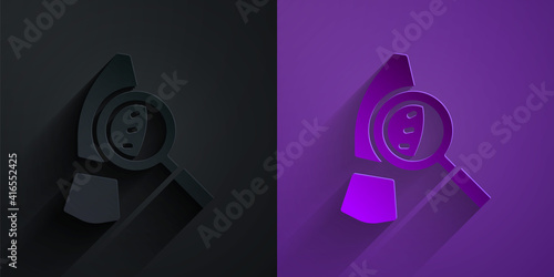 Paper cut Magnifying glass with footsteps icon isolated on black on purple background. Detective is investigating. To follow in the footsteps. Paper art style. Vector.