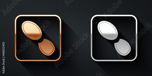 Gold and silver Human footprints shoes icon isolated on black background. Shoes sole. Long shadow style. Vector.