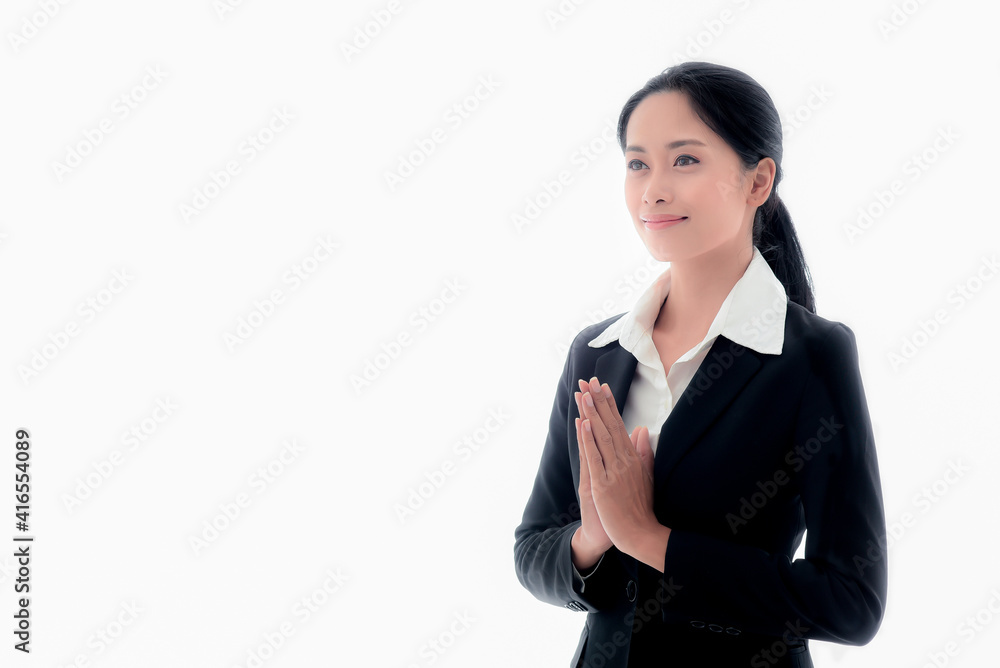 A smart and young Asian businessman with long black hair in a suit. Being greeted with 'Wai' or 'Sawasdee', with a smile and a friendly and friendly attitude on isolated white background A smart and young Asian businessman with long black hair in a suit. Being greeted with 'Wai' or 'Sawasdee', with a smile and a friendly and friendly attitude on isolated white background