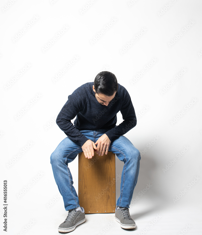 young man playing flamenco music cajon