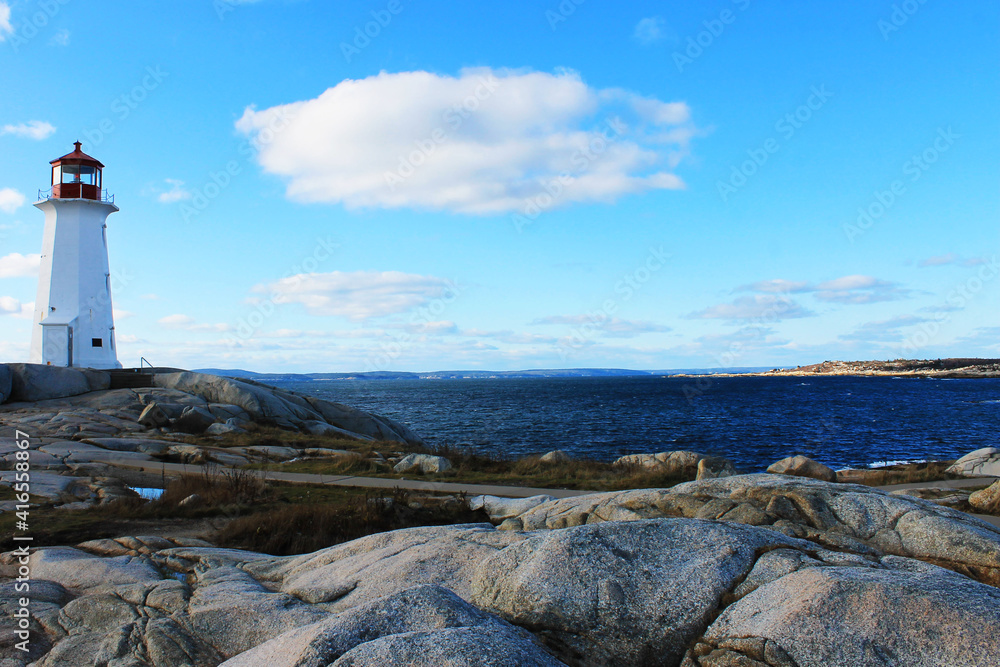 Light house at Peggy's Cove, Nova Scotia. Sunny, autumn day, lots of blue sky with light cloud. Lots of copy space.
