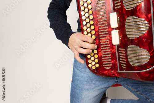 young man playing accordion on the white background