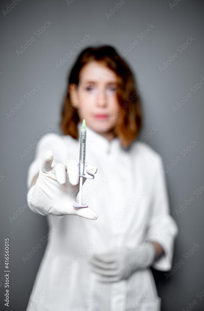 portrait of a female medical worker with a syringe in his hands portrait of a female medical worker with a syringe in his hands