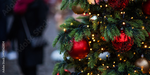 Decorated Christmas tree on blurred background. New Year's and Christmas holiday background with lights on tree.