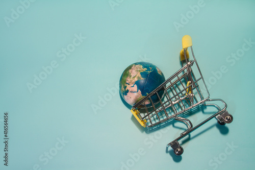 planet earth in supermarket trolley, online shopping. Concepth photo of Earth Day photo